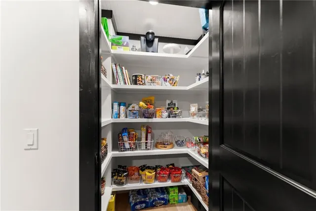 a view of a patio with a table chairs and wooden floor