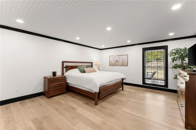 a spacious bedroom with a bed and a cabinets