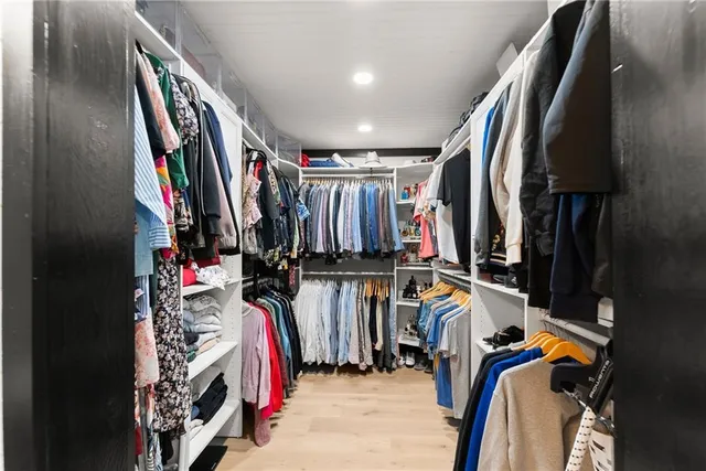 a front view of a house with a garden and swimming pool