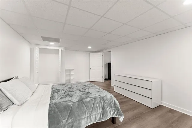 an aerial view of residential houses with outdoor space and trees