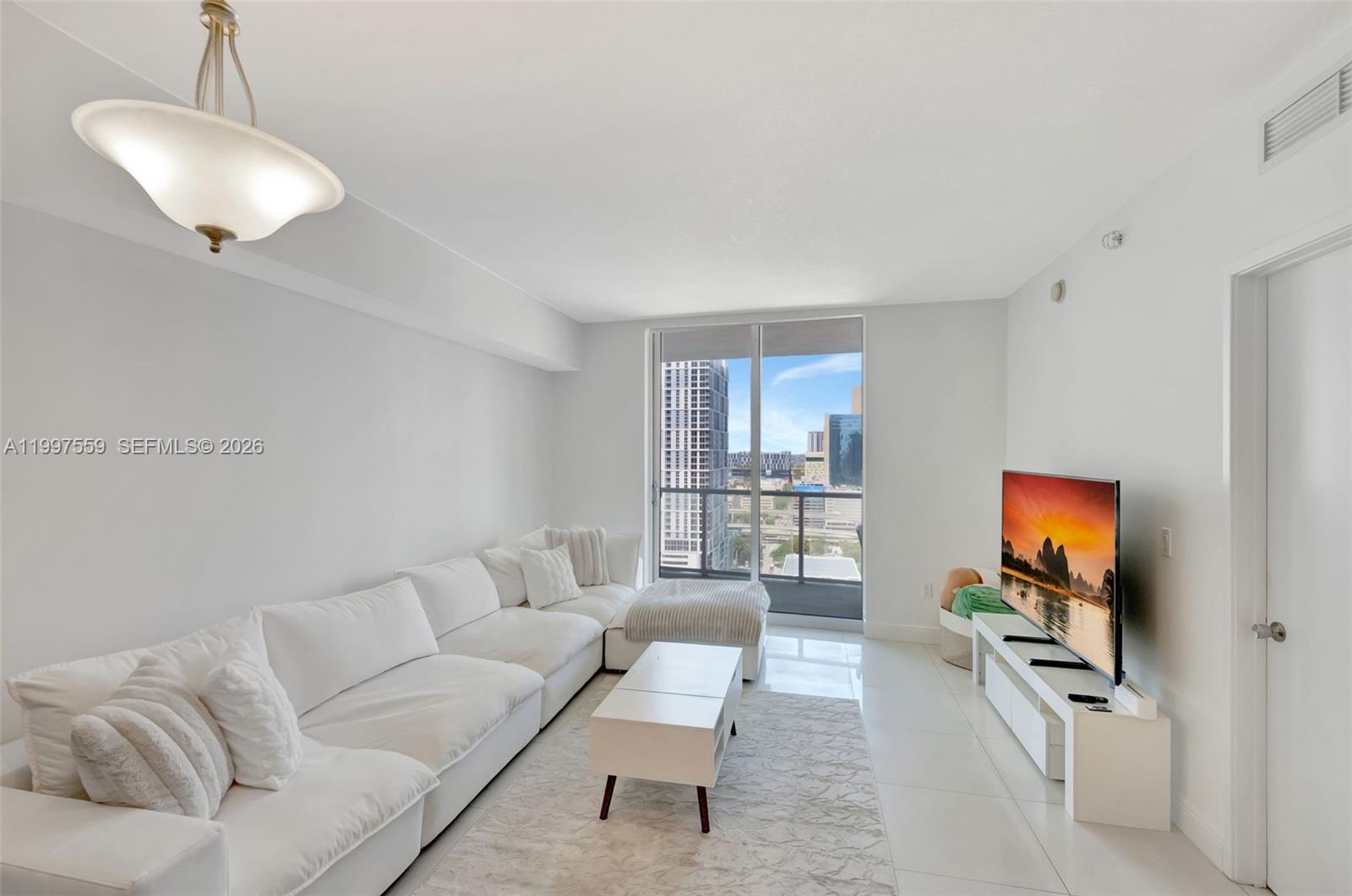 a living room with furniture and a flat screen tv