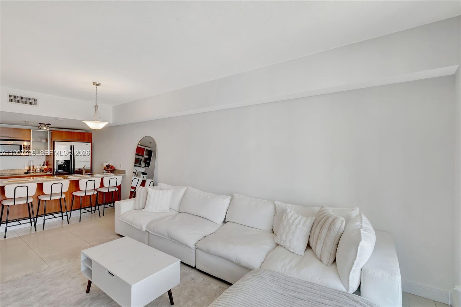 185 Southwest 7th Street, Unit 2303 Miami, FL 33130 - Photo 15 of 40 a living room with furniture and a wooden floor