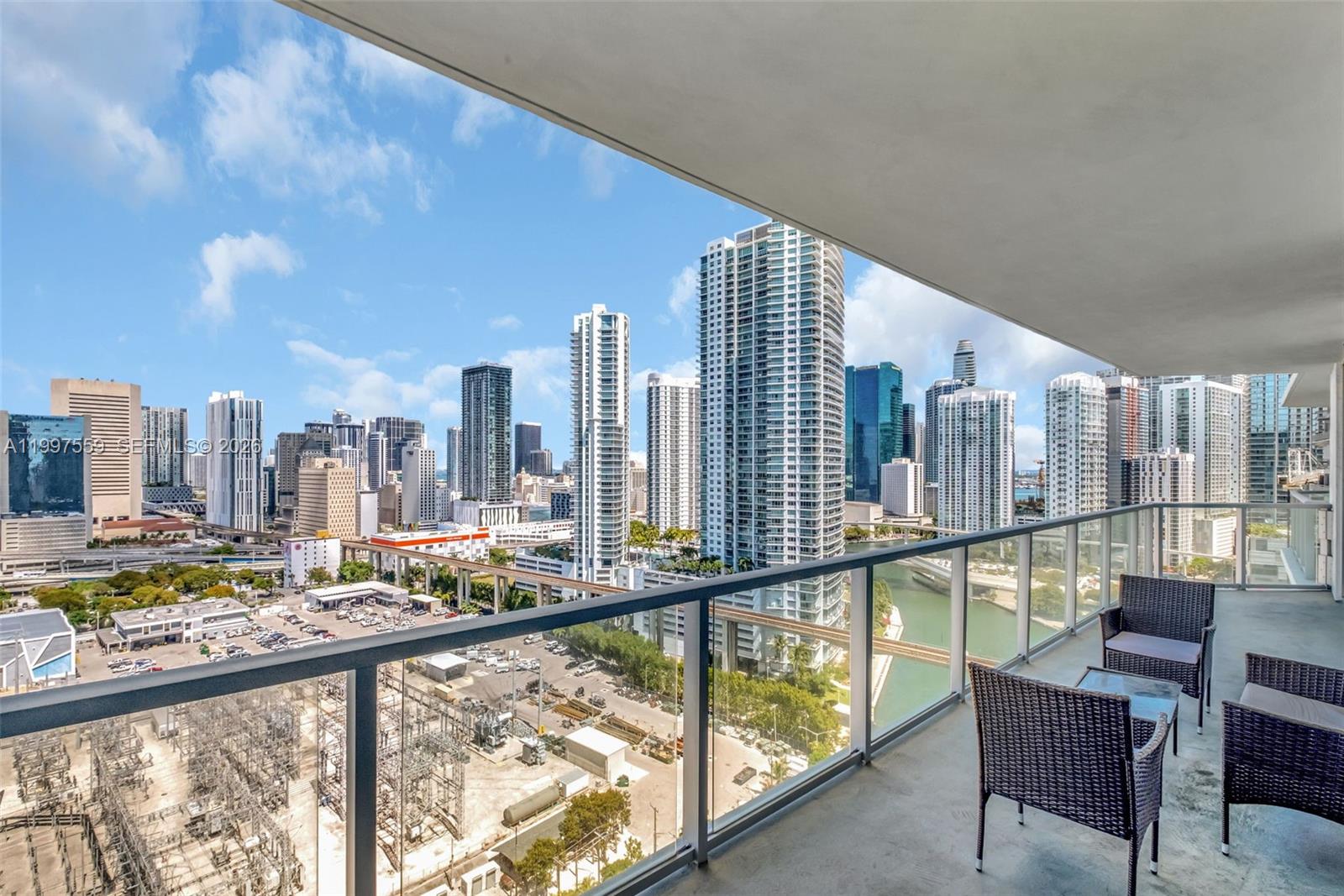 185 Southwest 7th Street, Unit 2303 Miami, FL 33130 - Photo 4 of 40 a view of a city from a balcony with furniture