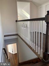9407 Colesville Road, Unit B Silver Spring, MD 20901 - Photo 19 of 48 Elegant staircase with classic railings.