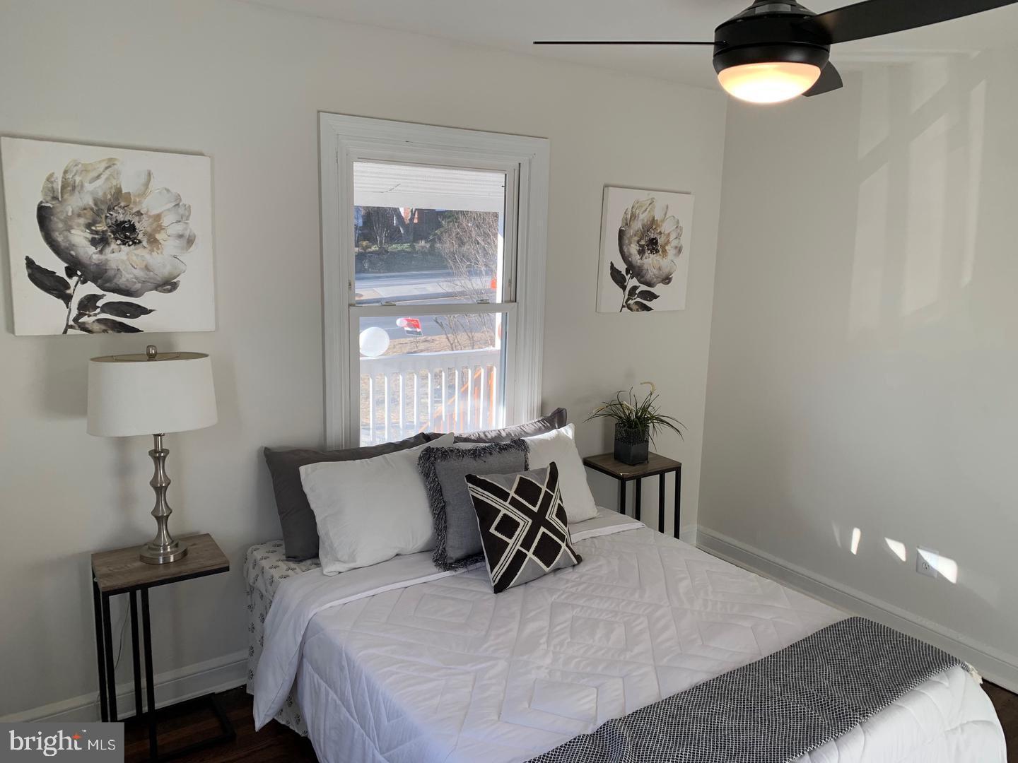 9407 Colesville Road, Unit B Silver Spring, MD 20901 - Photo 33 of 48 Bright and airy bedroom with floral accents.