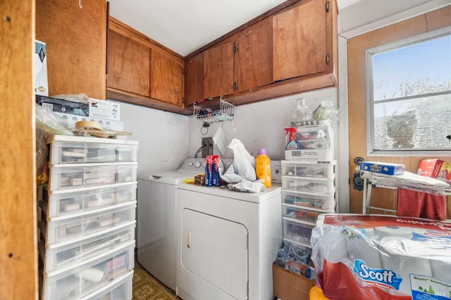 a view of storage and utility room with sink dryer and toys