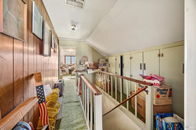a view of a hallway with the couches and chandelier