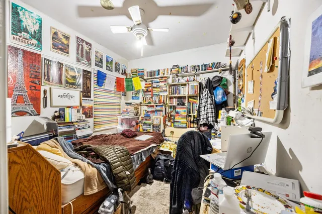 a view of a livingroom with workspace and a window