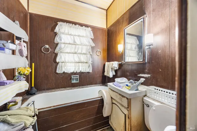 a bathroom with a sink a toilet and a window