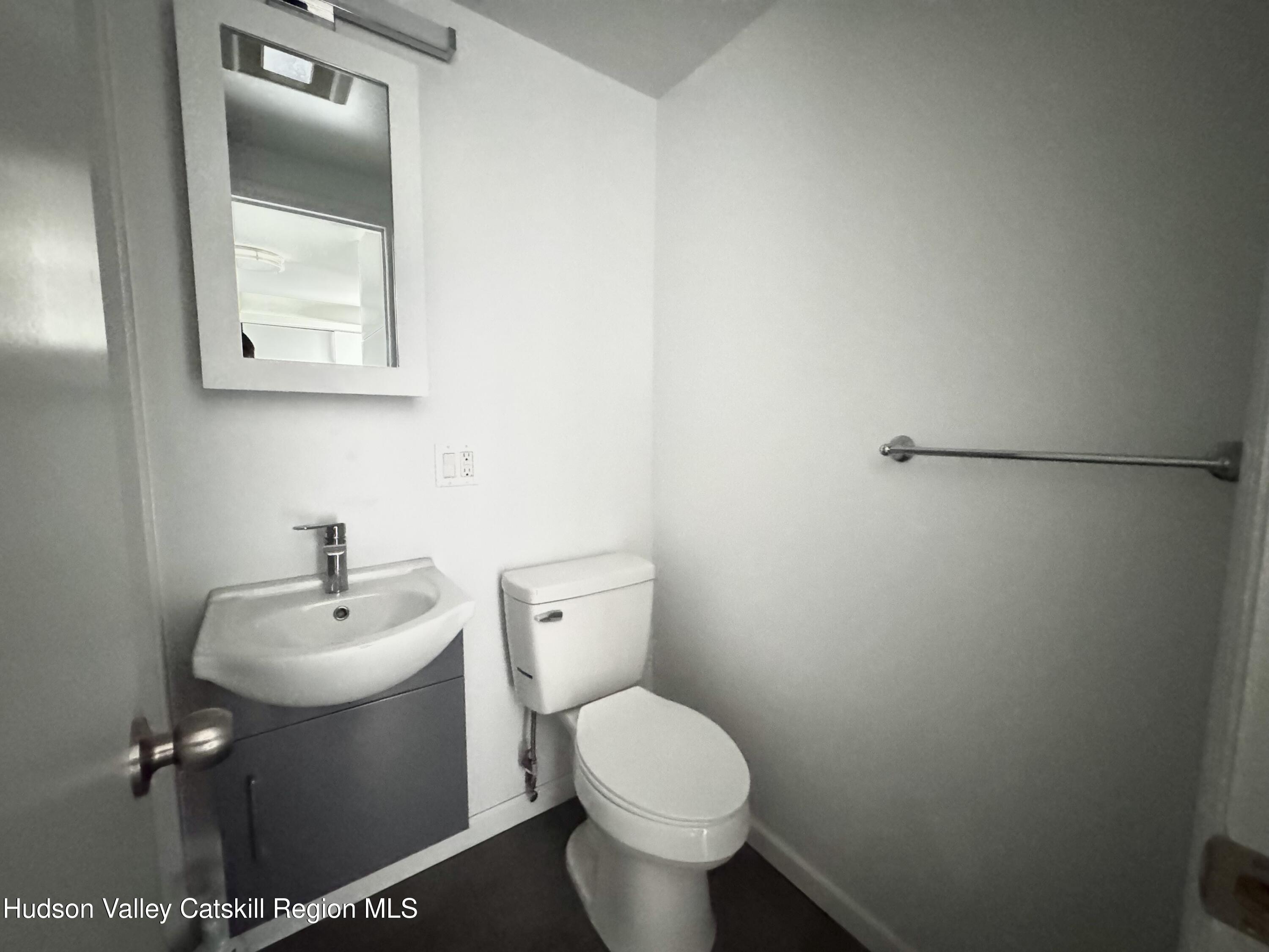 218 Water Street, Unit 5 Catskill, NY 12414 - Photo 8 of 12 a white toilet sitting next to a white sink