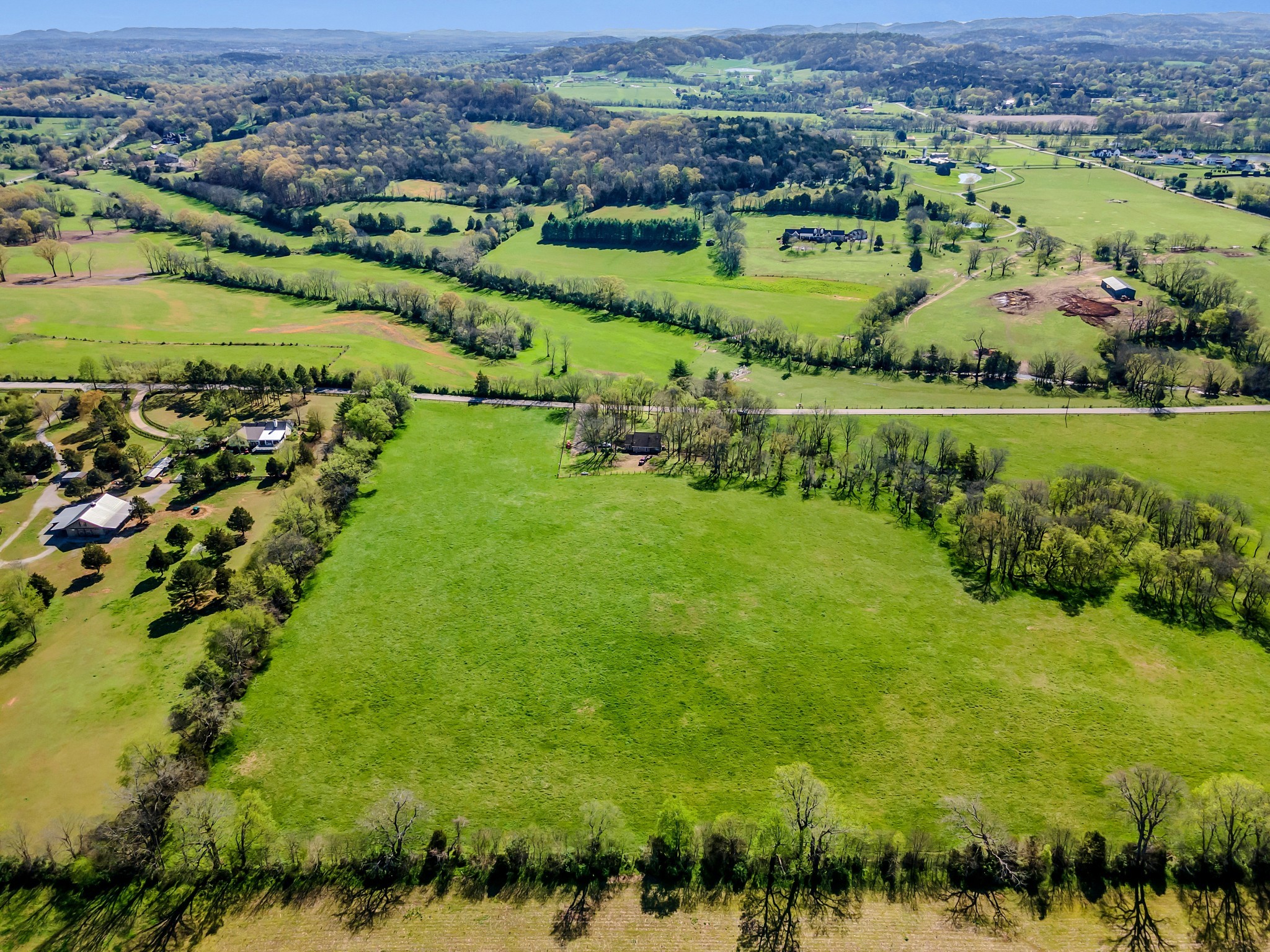 1365 Kittrell Road Franklin, TN 37064 - Photo 13 of 16 an aerial view of green landscape with trees houses and lake view