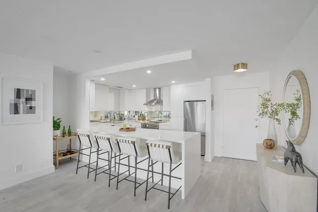 a view of a dining room with furniture and a potted plant