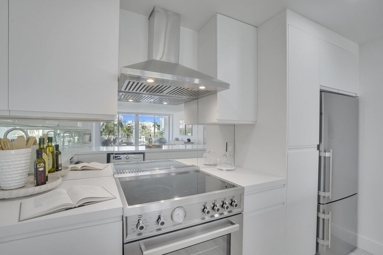 354 Chilean Avenue, Unit 4D Palm Beach, FL 33480 - Photo 19 of 23 a kitchen with a stove and white cabinets