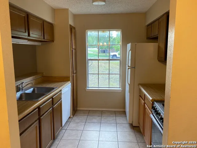 a kitchen with a refrigerator stove and microwave
