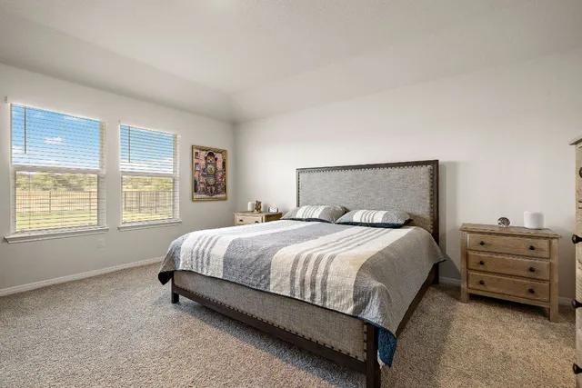 a bed sitting in a bedroom next to a window