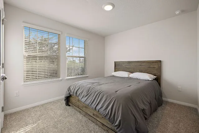 a bedroom with a bed and a window