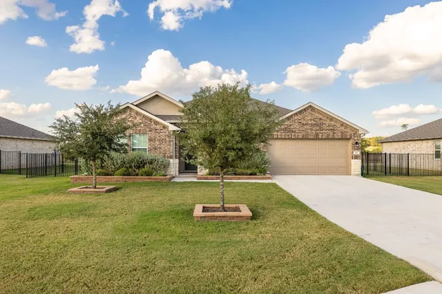 a backyard of a house with table and chairs