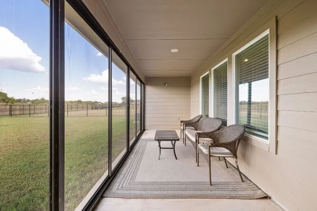 a view of a living room and a floor to ceiling window