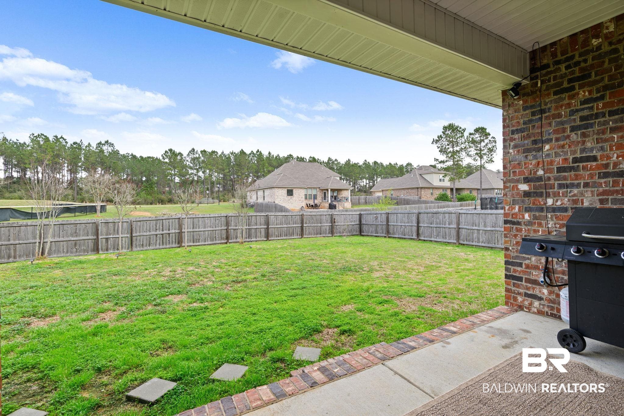 12693 Waxwing Avenue Daphne, AL 36527 - Photo 9 of 43 Fenced backyard featuring a patio and a residential view