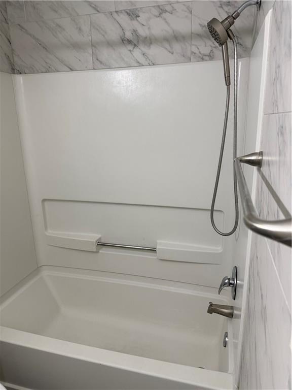 a bathroom with a shower and a bath tub