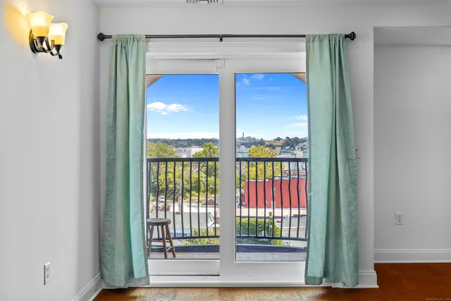 a kitchen with a sink a chandelier and wooden floor
