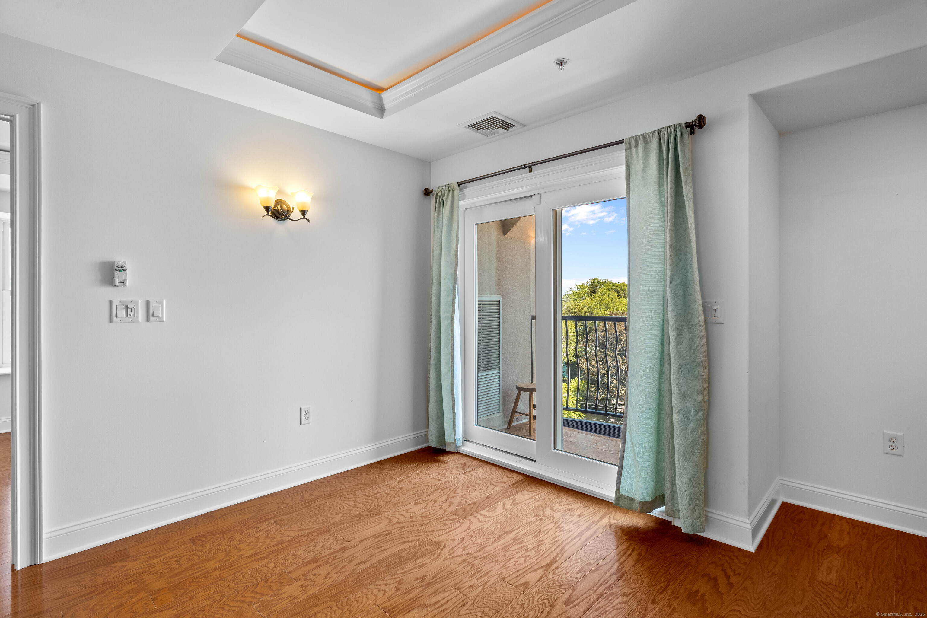 461 Bank Street, Unit 802 New London, CT 06320 - Photo 14 of 35 an empty room with wooden floor and windows