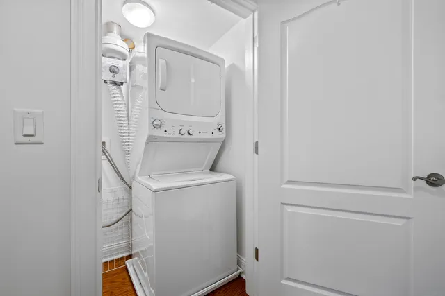 a view of a livingroom with a fireplace a microwave and a ceiling fan