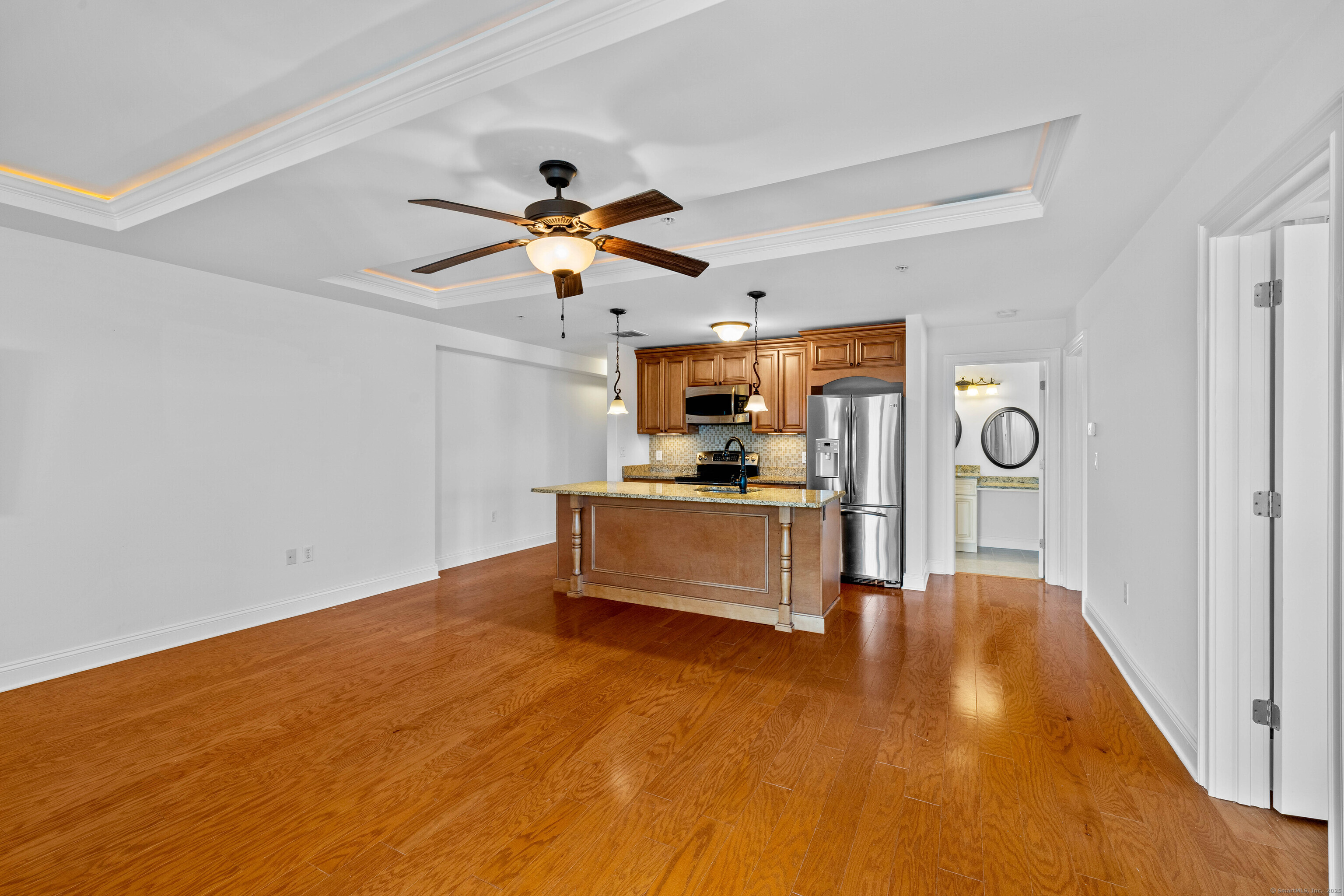 461 Bank Street, Unit 802 New London, CT 06320 - Photo 7 of 35 a view of a livingroom with a fireplace a microwave and a ceiling fan