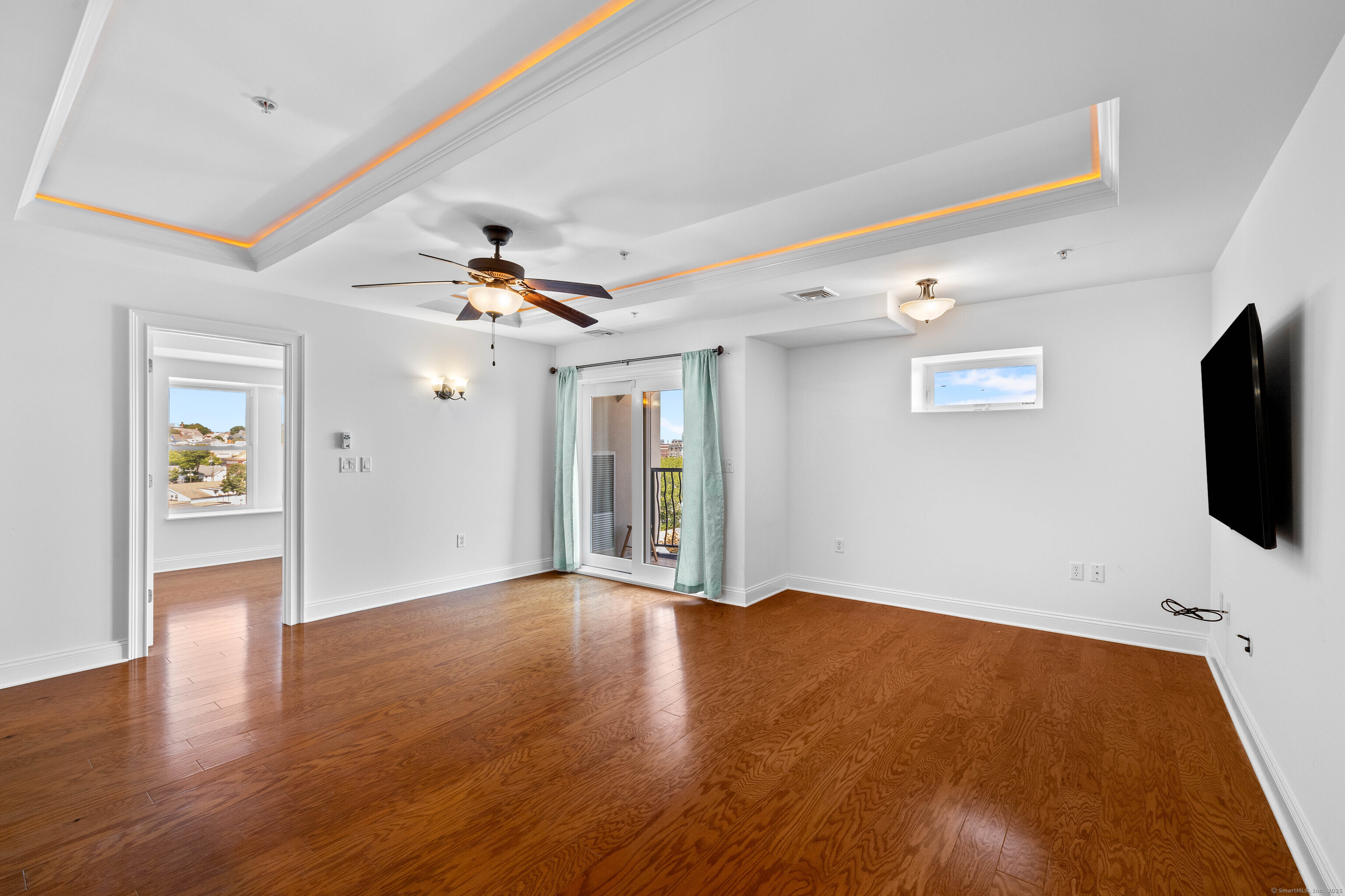 461 Bank Street, Unit 802 New London, CT 06320 - Photo 9 of 35 a view of an empty room with window and wooden floor