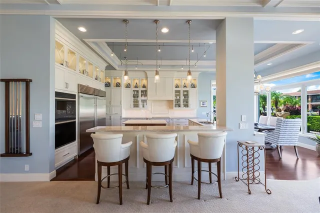 a view of a lake with couches of water fountain and wooden floor