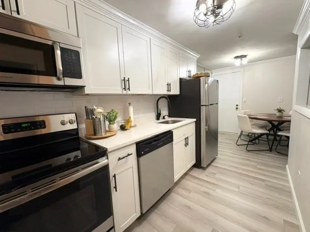 a kitchen with a sink stainless steel appliances and cabinets
