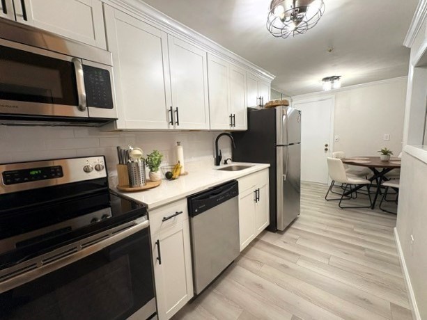 a kitchen with a sink stainless steel appliances and cabinets