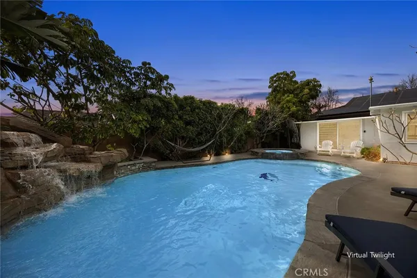 a view of a backyard with plants and a patio
