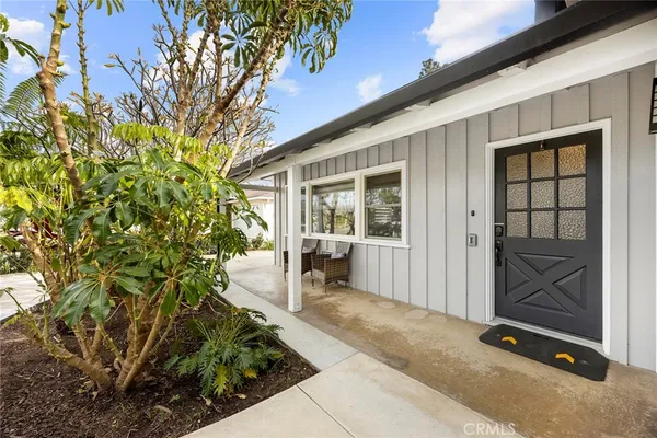 a living room with furniture wooden floor and wall painting