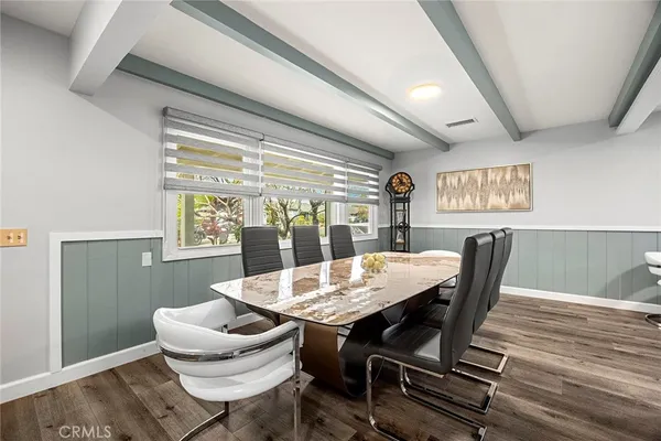 a large kitchen with a lot of counter space and wooden floor
