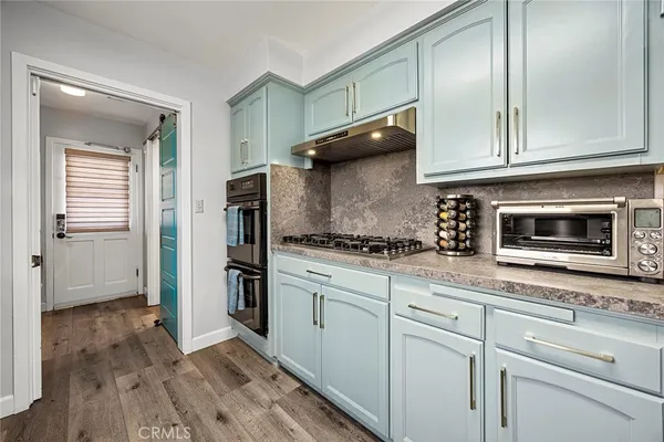 a en suite bathroom with a granite countertop sink and a large mirror