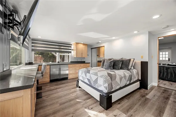 a bedroom with a bed and wooden floor
