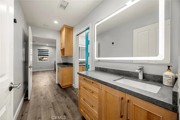 a bedroom with a bed a table and painting