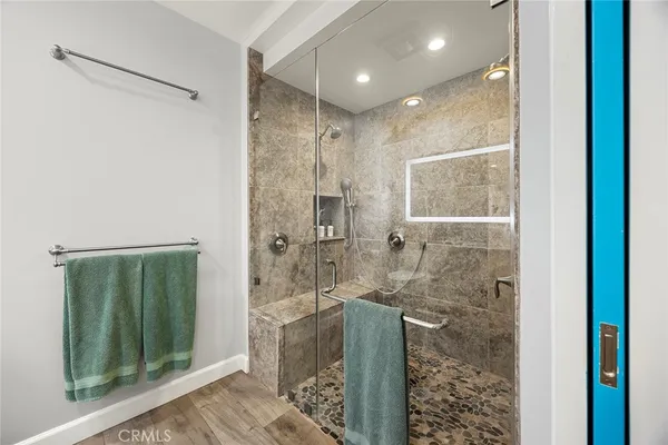 a bathroom with a sink a mirror and a shower