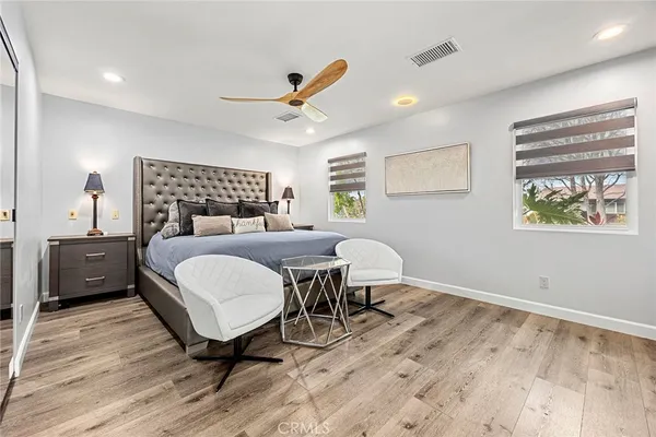 a bedroom with a bed and a table next to a window