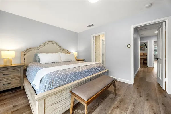 a bedroom with furniture and a wooden floor