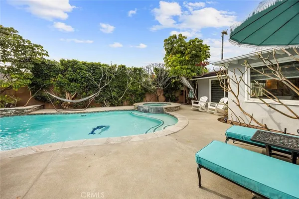 a large kitchen with stainless steel appliances granite countertop a stove a sink and white cabinets