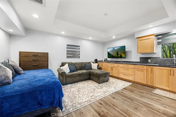 a bathroom with a granite countertop sink a toilet a shower and a mirror