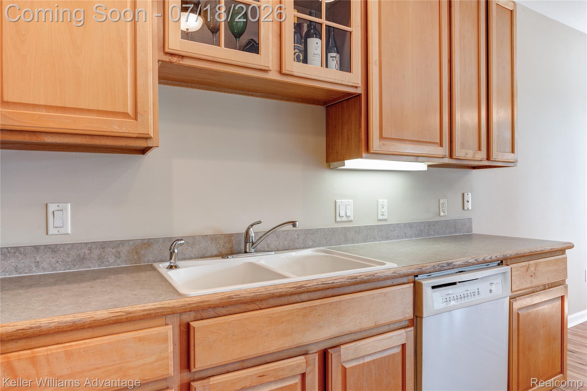 41647 Mitchell Road Novi, MI 48377 - Photo 21 of 43 Light wood-finish cabinetry featuring a glass-front upper cabinet