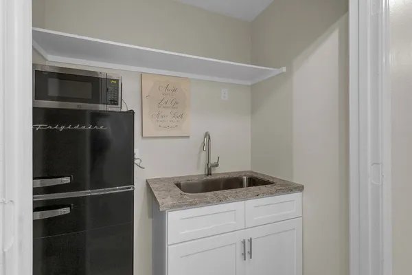 a bed room with a bed tv and a window