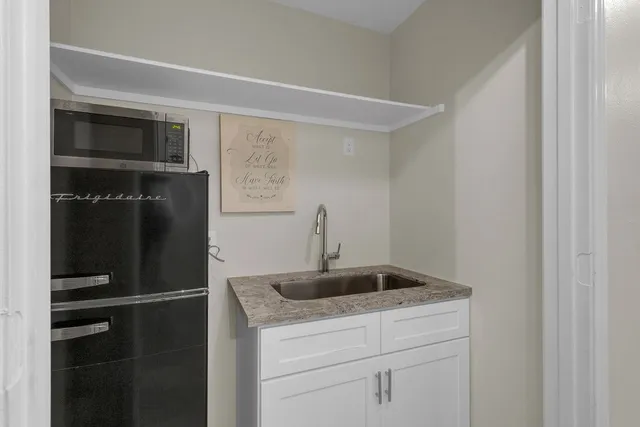 a bed room with a bed tv and a window