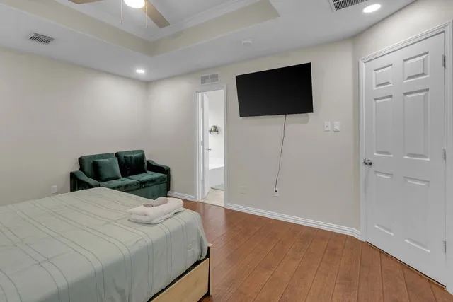 a living room with toilet and a mirror
