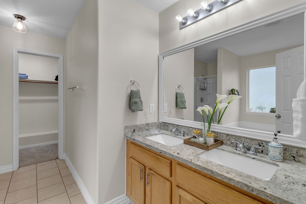 746 Cape Cottage Lane Spring, TX 77373 - Photo 26 of 36 a bathroom with a granite countertop sink and a mirror