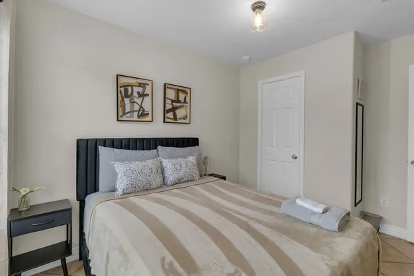 a bedroom with a bed and a chair