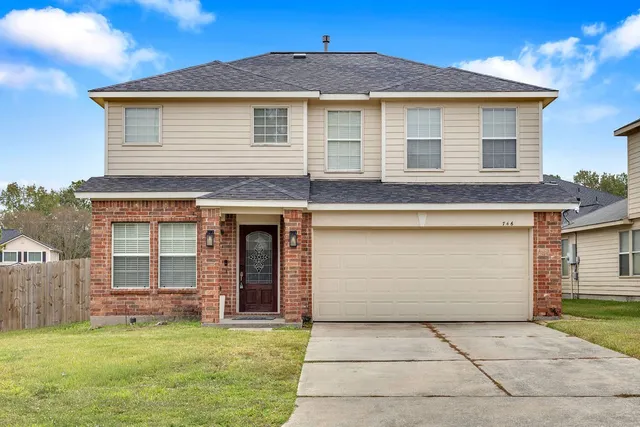 a view of a yard with wooden fence
